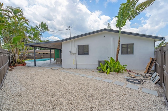 3732 SW 16th St, Fort Lauderdale, FL 33312 - back of house with a fenced backyard, a patio, stucco siding, and central air condition unit