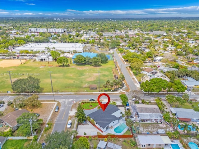 aerial view of property and surrounding area with a pool area