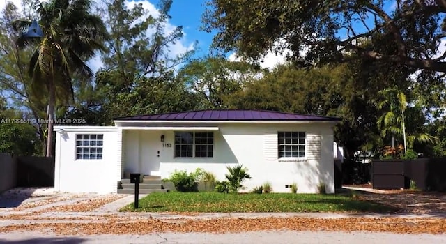 1153 NE 158th St, North Miami Beach, FL 33162 - view of front of property with stucco siding, a standing seam roof, and metal roof