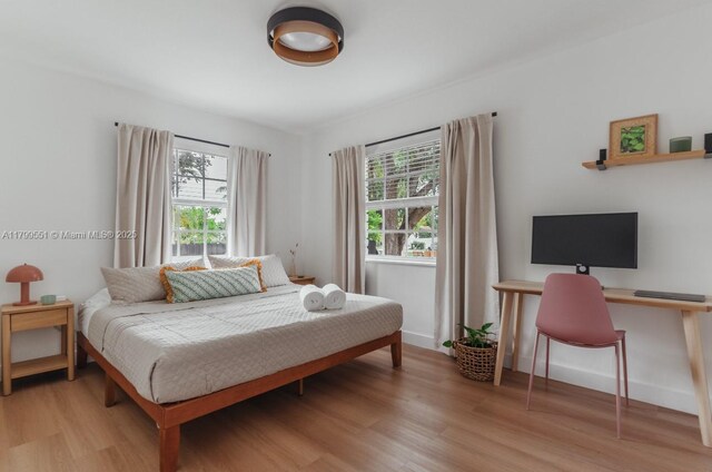 1153 NE 158th St, North Miami Beach, FL 33162 - bedroom with multiple windows and wood finished floors