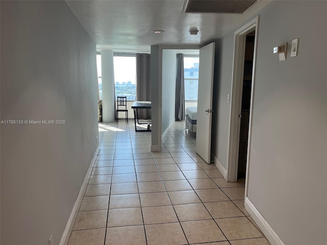 900 Bay Dr Unit 913, Miami Beach, FL 33141 - hallway featuring light tile patterned floors and baseboards