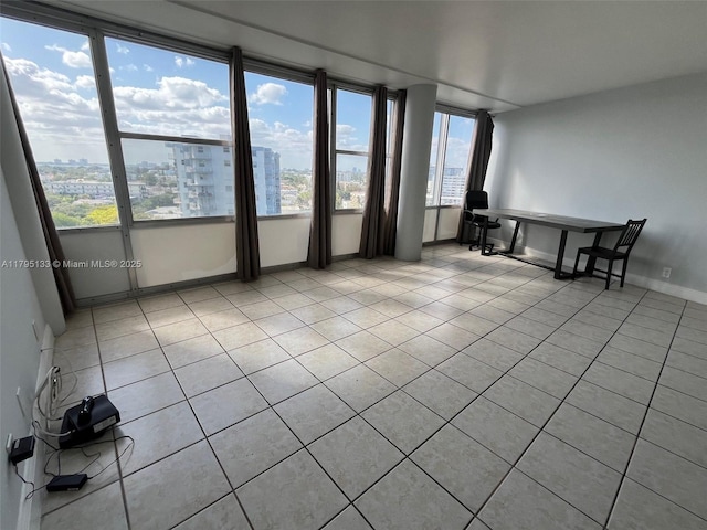 900 Bay Dr Unit 913, Miami Beach, FL 33141 - spare room with light tile patterned flooring, a view of city, and baseboards