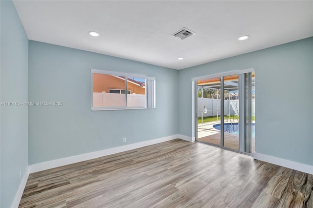 5261 NE 18th Ter, Fort Lauderdale, FL 33308 - spare room with wood finished floors, baseboards, and recessed lighting
