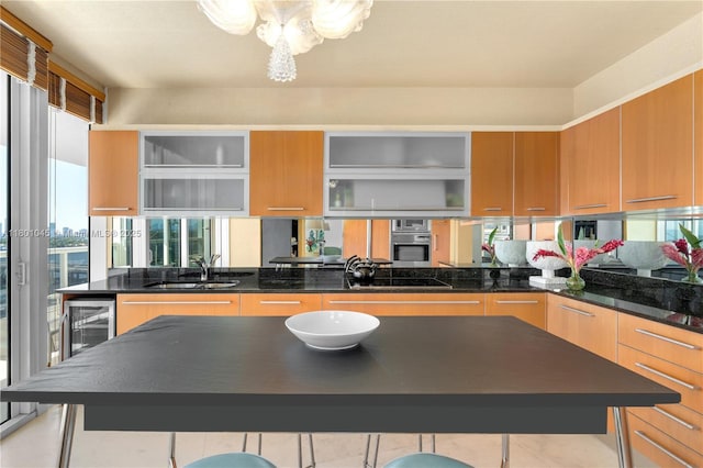 400 Alton Rd Unit 1101, Miami Beach, FL 33139 - kitchen featuring oven, wine cooler, a sink, a chandelier, and dark countertops