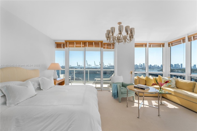 400 Alton Rd Unit 1101, Miami Beach, FL 33139 - bedroom with a chandelier, a view of skyline, a wall of windows, carpet flooring, and access to outside
