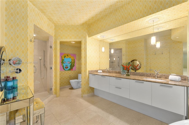400 Alton Rd Unit 1101, Miami Beach, FL 33139 - bathroom featuring toilet, wallpapered walls, a stall shower, double vanity, and tile patterned flooring