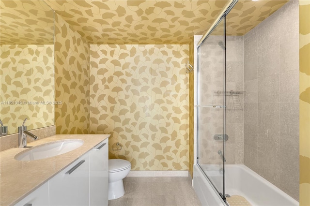 400 Alton Rd Unit 1101, Miami Beach, FL 33139 - full bathroom with wallpapered walls, baseboards, vanity, toilet, and combined bath / shower with glass door