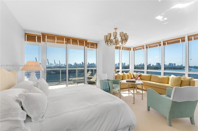 400 Alton Rd Unit 1101, Miami Beach, FL 33139 - carpeted bedroom with a skyline view, a chandelier, access to outside, and a water view