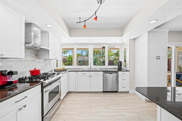 5318 Garfield St, Hollywood, FL 33021 - kitchen with appliances with stainless steel finishes, wall chimney range hood, a sink, decorative backsplash, and recessed lighting