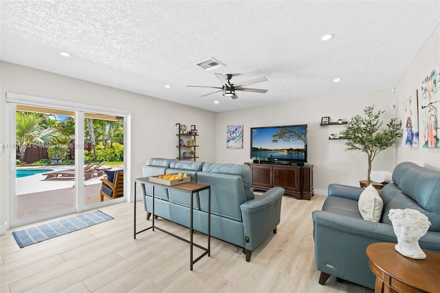 5318 Garfield St, Hollywood, FL 33021 - living room featuring a ceiling fan, light wood-style floors, a textured ceiling, and recessed lighting
