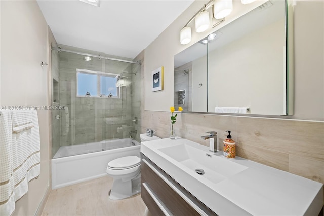 5318 Garfield St, Hollywood, FL 33021 - bathroom featuring tile walls, toilet, enclosed tub / shower combo, and vanity