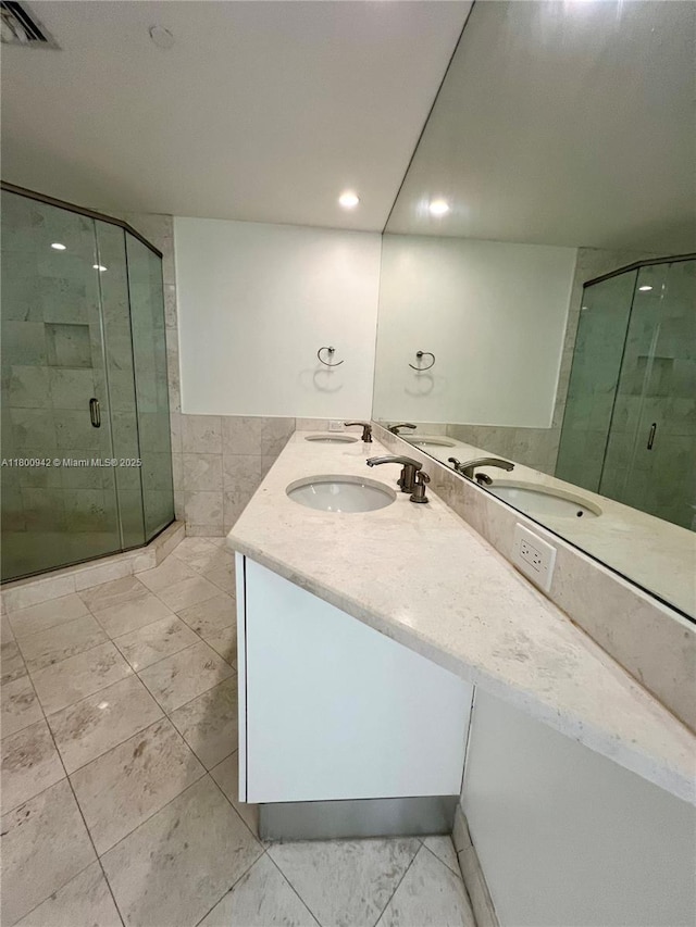 901 Brickell Key Blvd Unit 603, Miami, FL 33131 - full bathroom with a shower stall, double vanity, tile walls, and recessed lighting