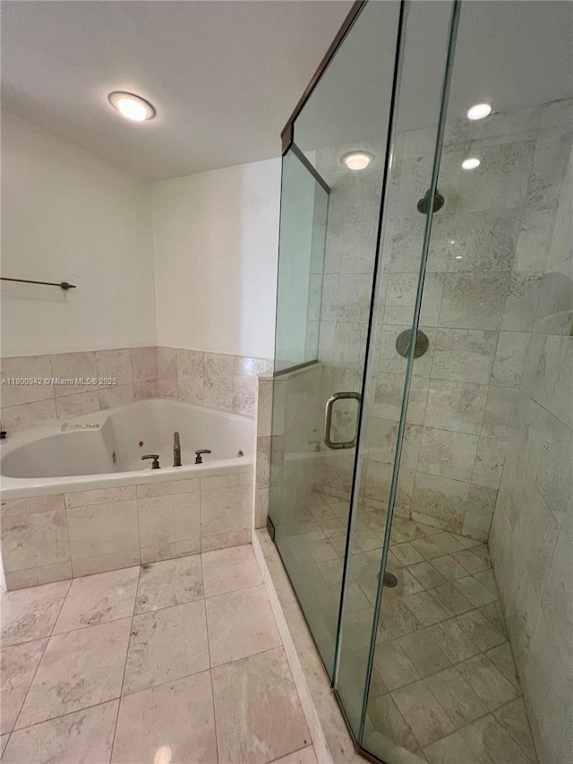 901 Brickell Key Blvd Unit 603, Miami, FL 33131 - bathroom featuring a shower stall, a tub with jets, and tile patterned floors