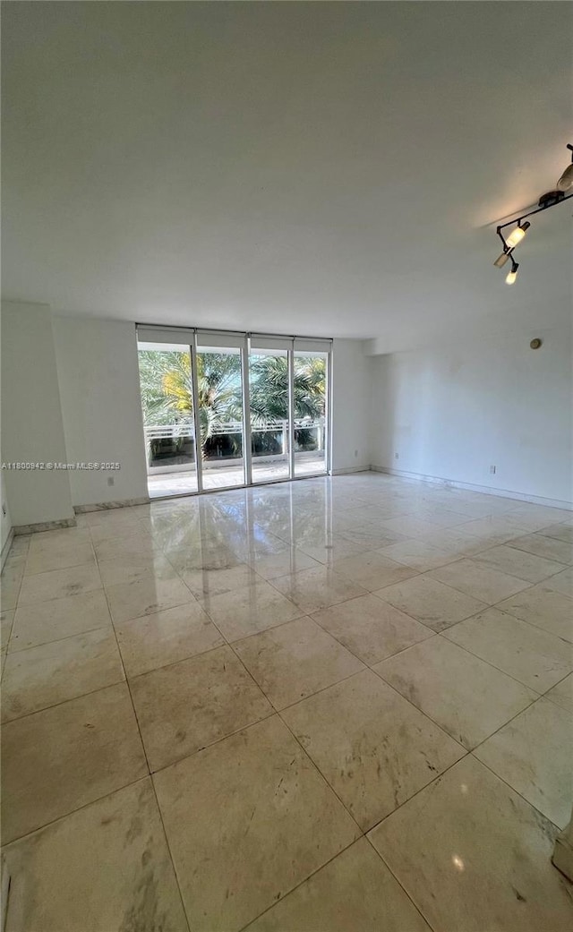 901 Brickell Key Blvd Unit 603, Miami, FL 33131 - spare room with plenty of natural light, light tile patterned floors, and baseboards