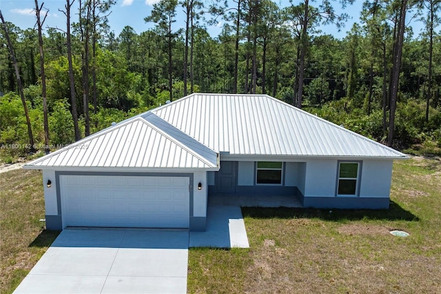 2004 Rosa Ct, Lehigh Acres, FL 33972 - view of front facade with a garage, metal roof, stucco siding, and driveway