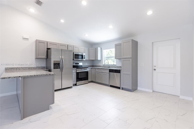 2004 Rosa Ct, Lehigh Acres, FL 33972 - kitchen featuring stainless steel appliances, gray cabinets, a sink, a peninsula, and baseboards
