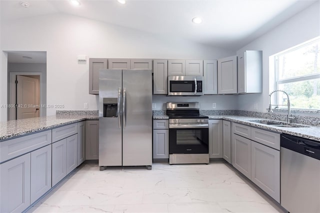 2004 Rosa Ct, Lehigh Acres, FL 33972 - kitchen featuring stainless steel appliances, a sink, gray cabinets, lofted ceiling, and light marble finish flooring