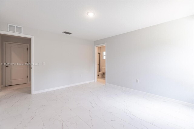 2004 Rosa Ct, Lehigh Acres, FL 33972 - unfurnished room featuring light marble finish floors and baseboards