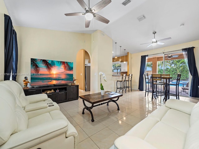 18760 SW 358th St, Homestead, FL 33034 - living room with a ceiling fan, arched walkways, light tile patterned floors, and vaulted ceiling