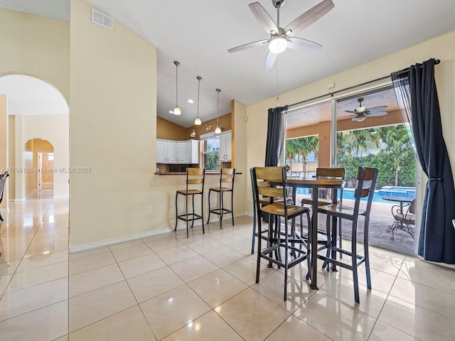 18760 SW 358th St, Homestead, FL 33034 - dining room with ceiling fan, arched walkways, lofted ceiling, light tile patterned flooring, and baseboards