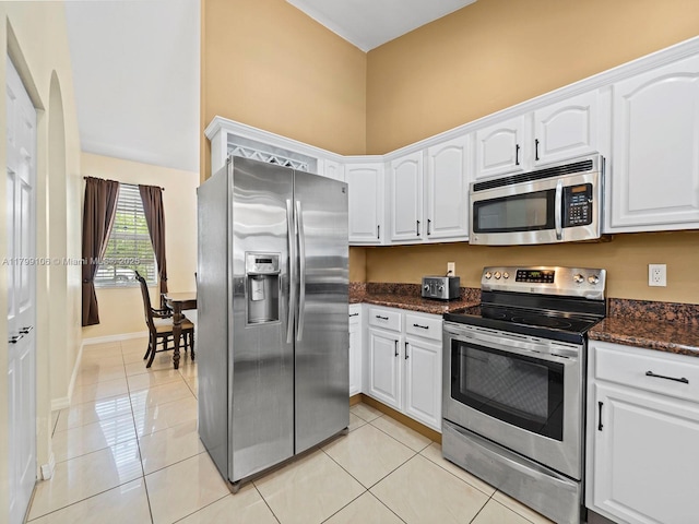 18760 SW 358th St, Homestead, FL 33034 - kitchen featuring appliances with stainless steel finishes, light tile patterned flooring, white cabinetry, and baseboards