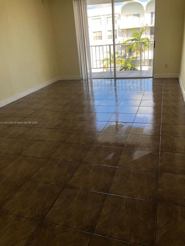 492 NW 165th St Rd Unit C514, Miami, FL 33169 - empty room with baseboards and dark tile patterned floors