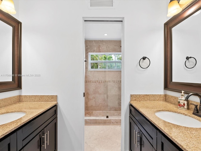 1125 Asturia Ave, Coral Gables, FL 33134 - full bath with tiled shower, two vanities, and tile patterned flooring