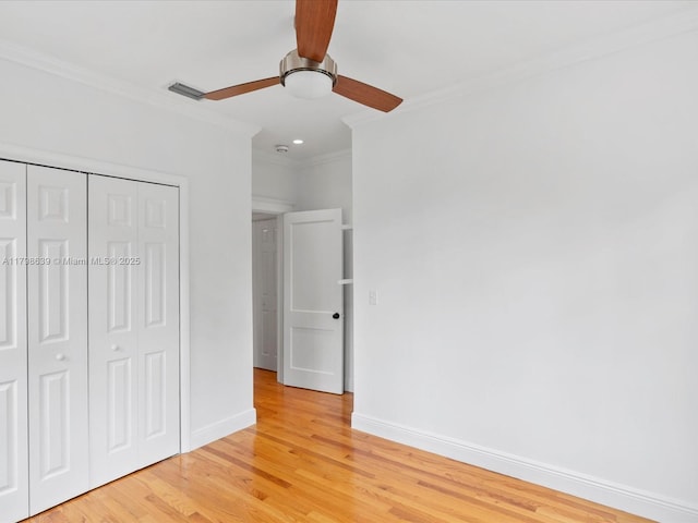 1125 Asturia Ave, Coral Gables, FL 33134 - unfurnished bedroom featuring ornamental molding, light wood finished floors, a closet, baseboards, and ceiling fan