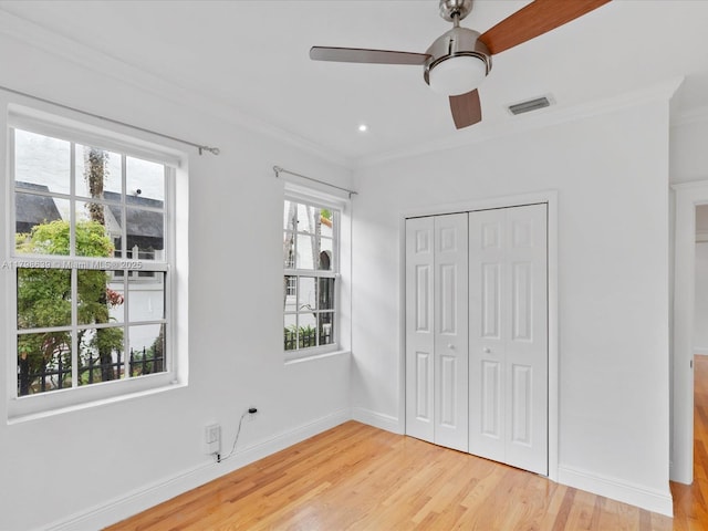 1125 Asturia Ave, Coral Gables, FL 33134 - unfurnished bedroom with light wood finished floors, ornamental molding, a closet, baseboards, and a ceiling fan