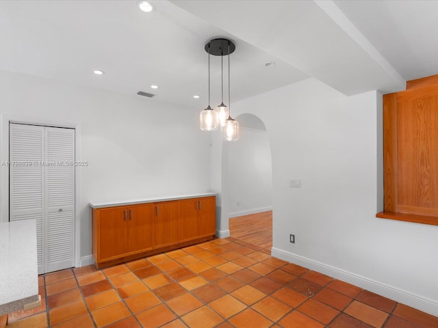 1125 Asturia Ave, Coral Gables, FL 33134 - unfurnished room featuring baseboards, recessed lighting, arched walkways, and light tile patterned flooring