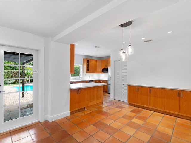 1125 Asturia Ave, Coral Gables, FL 33134 - kitchen featuring stainless steel appliances, a peninsula, light countertops, a sink, and light tile patterned flooring