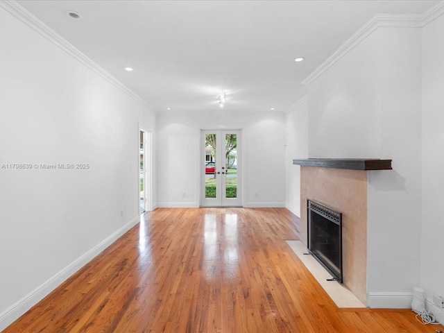 1125 Asturia Ave, Coral Gables, FL 33134 - unfurnished living room featuring light wood-style flooring, a fireplace with flush hearth, baseboards, recessed lighting, and french doors