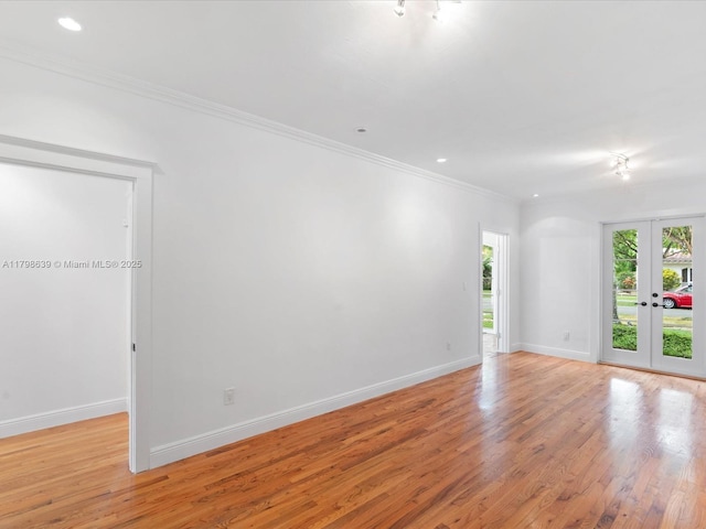 1125 Asturia Ave, Coral Gables, FL 33134 - empty room featuring french doors, light wood finished floors, baseboards, ornamental molding, and recessed lighting