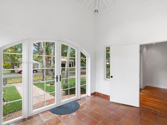 1125 Asturia Ave, Coral Gables, FL 33134 - doorway to outside featuring french doors, baseboards, and a towering ceiling
