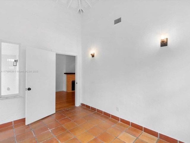 1125 Asturia Ave, Coral Gables, FL 33134 - spare room with a towering ceiling and baseboards