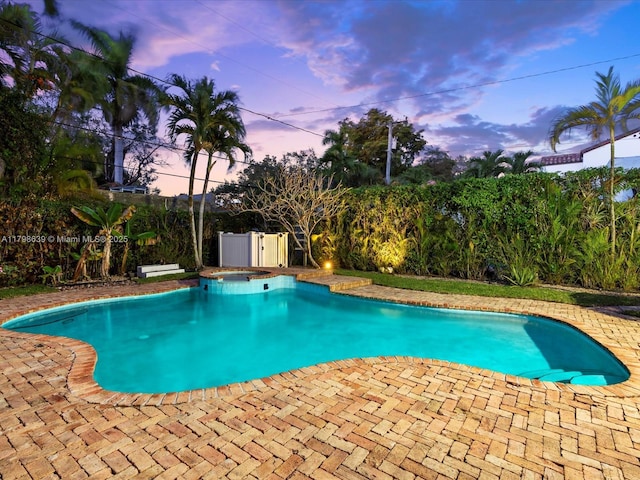 1125 Asturia Ave, Coral Gables, FL 33134 - pool at dusk featuring an in-ground hot tub