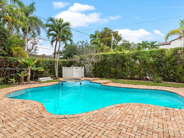 1125 Asturia Ave, Coral Gables, FL 33134 - view of swimming pool with a fenced backyard, a patio, and a pool with connected hot tub