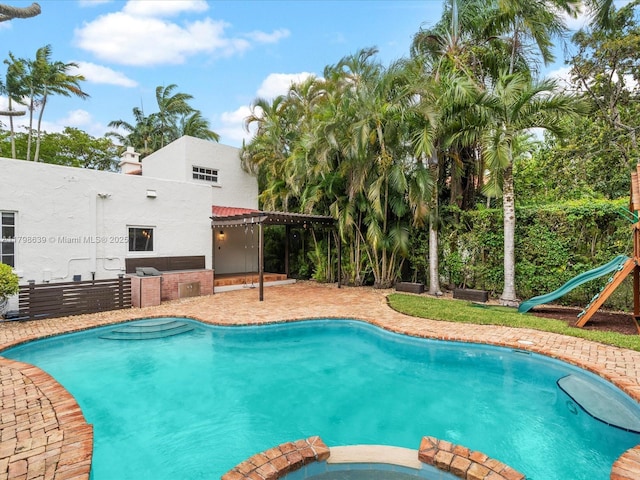 1125 Asturia Ave, Coral Gables, FL 33134 - view of pool with a pool with connected hot tub and a patio