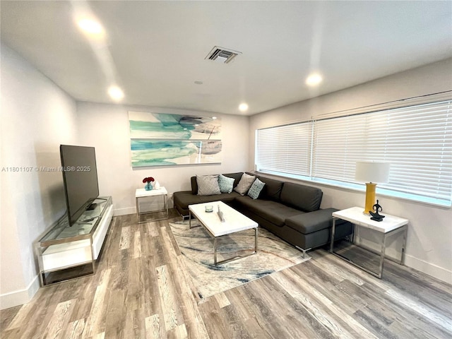 1900 NE 180th St, North Miami Beach, FL 33162 - living room with wood finished floors, baseboards, recessed lighting, and plenty of natural light