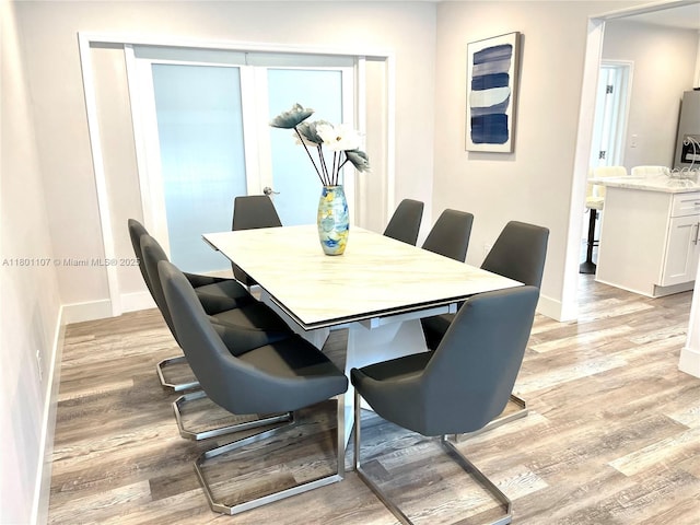 1900 NE 180th St, North Miami Beach, FL 33162 - dining room with baseboards and light wood-type flooring