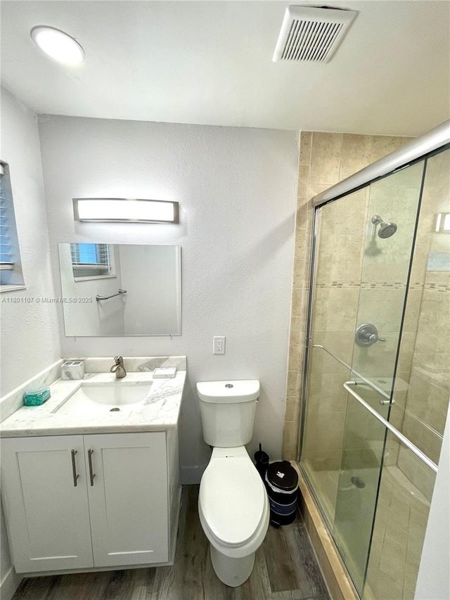 1900 NE 180th St, North Miami Beach, FL 33162 - full bathroom with wood finished floors, a shower stall, vanity, toilet, and a textured wall