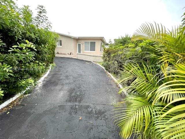 1900 NE 180th St, North Miami Beach, FL 33162 - view of front of house featuring asphalt driveway