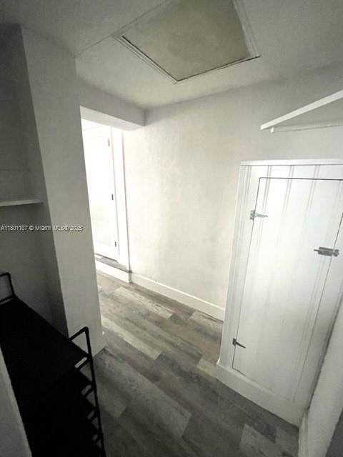 1900 NE 180th St, North Miami Beach, FL 33162 - hallway featuring wood finished floors and baseboards