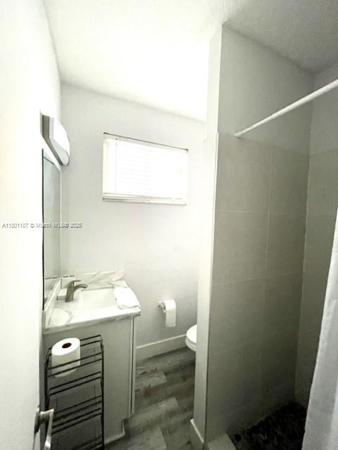 1900 NE 180th St, North Miami Beach, FL 33162 - full bath featuring a stall shower, vanity, toilet, and wood finished floors