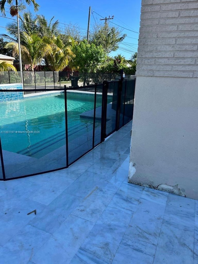 1900 NE 180th St, North Miami Beach, FL 33162 - view of swimming pool with fence and a patio area