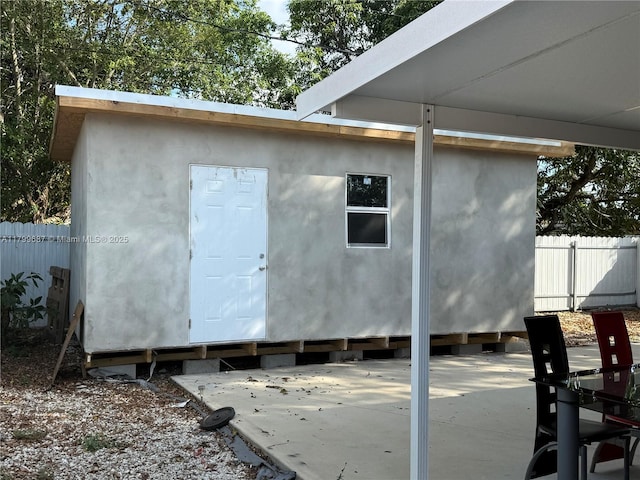 view of outdoor structure featuring fence