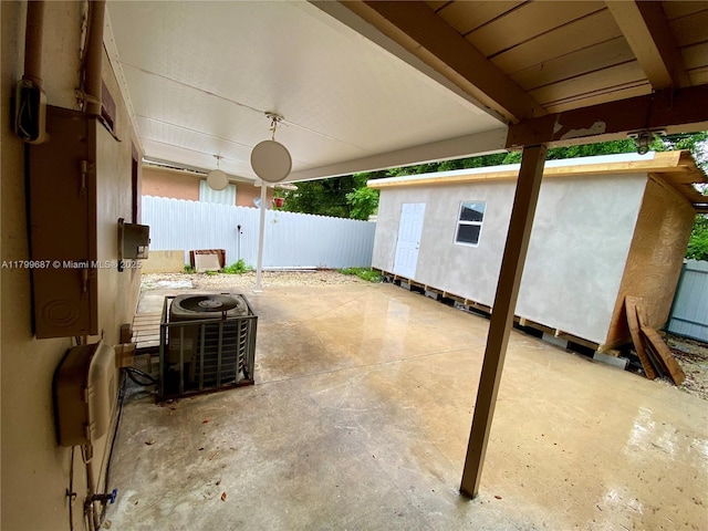 view of patio featuring cooling unit and fence