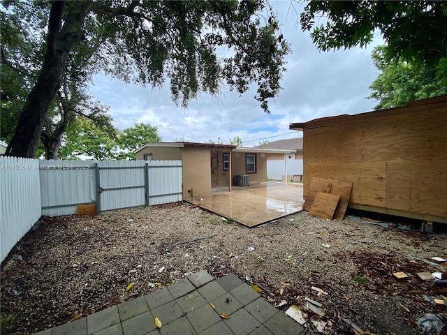 rear view of property featuring a patio, a fenced backyard, cooling unit, and stucco siding