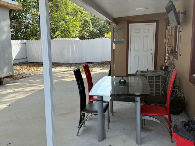 view of patio / terrace featuring fence, central air condition unit, and outdoor dining area