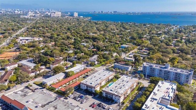 9020 NE 8th Ave Unit 2A, Miami Shores, FL 33138 - pool at dusk featuring a lawn